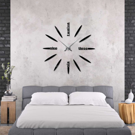 Stílusos 3D-s óra, amelyen a hagyományos számok helyett tizenkettő, három, hat és kilenc látható.